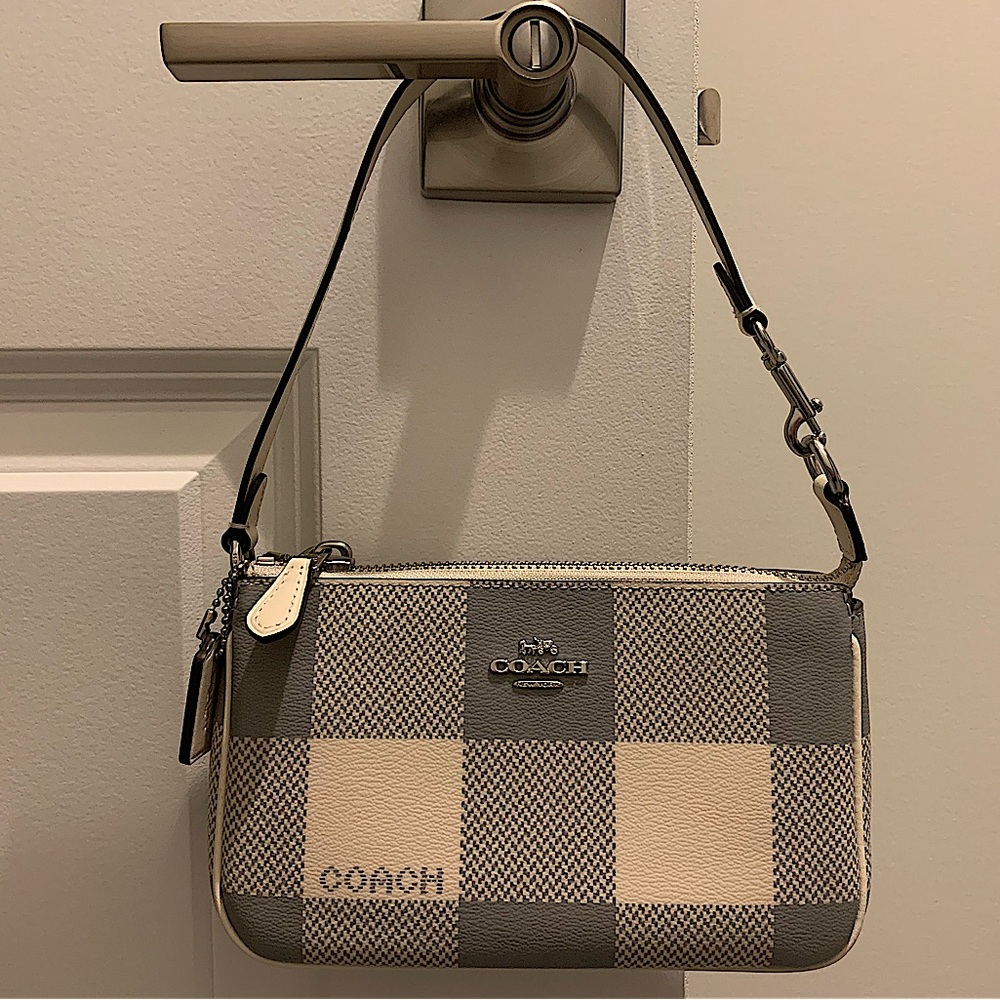 Coach Nolita 19 Wristlet with Buffalo Plaid print in chalk white and gray.